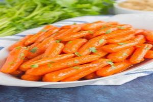 A plate of carrots on top of a table.