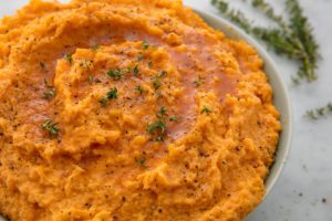 A close up of mashed sweet potatoes in a bowl